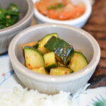 chopped marinated cucumbers in a small white dish