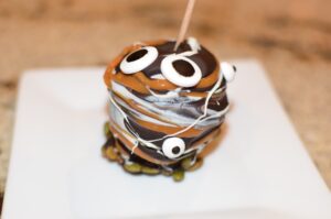 chocolate caramel apples decorated with googly eyes