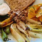 Roasted fennel slices, shishito peppers, sliced oranges plated with toasted bread and burrata cheese.