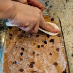 Pressing the 40 30 30 power bars into the prepared glass baking dish.