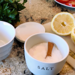 Ingredients on the counter ready to make lemon caprese, parsley, salt, lemons, tomatoes