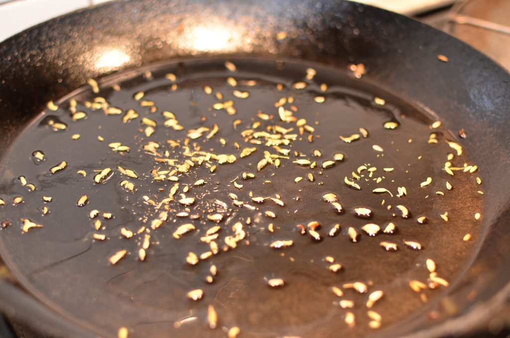 Sautéeing spices in oil in a pan