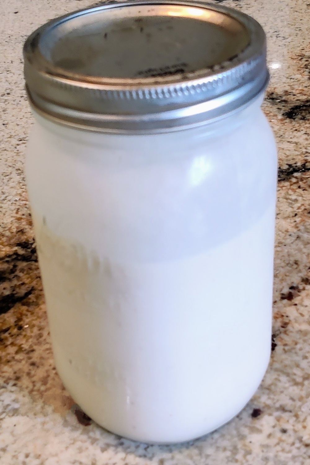 Salt and straw ice cream base chilling in a glass jar.