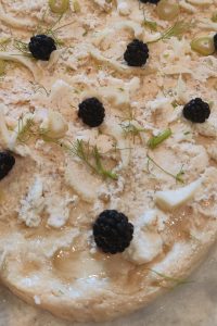 Blackberries and fennel on pizza dough