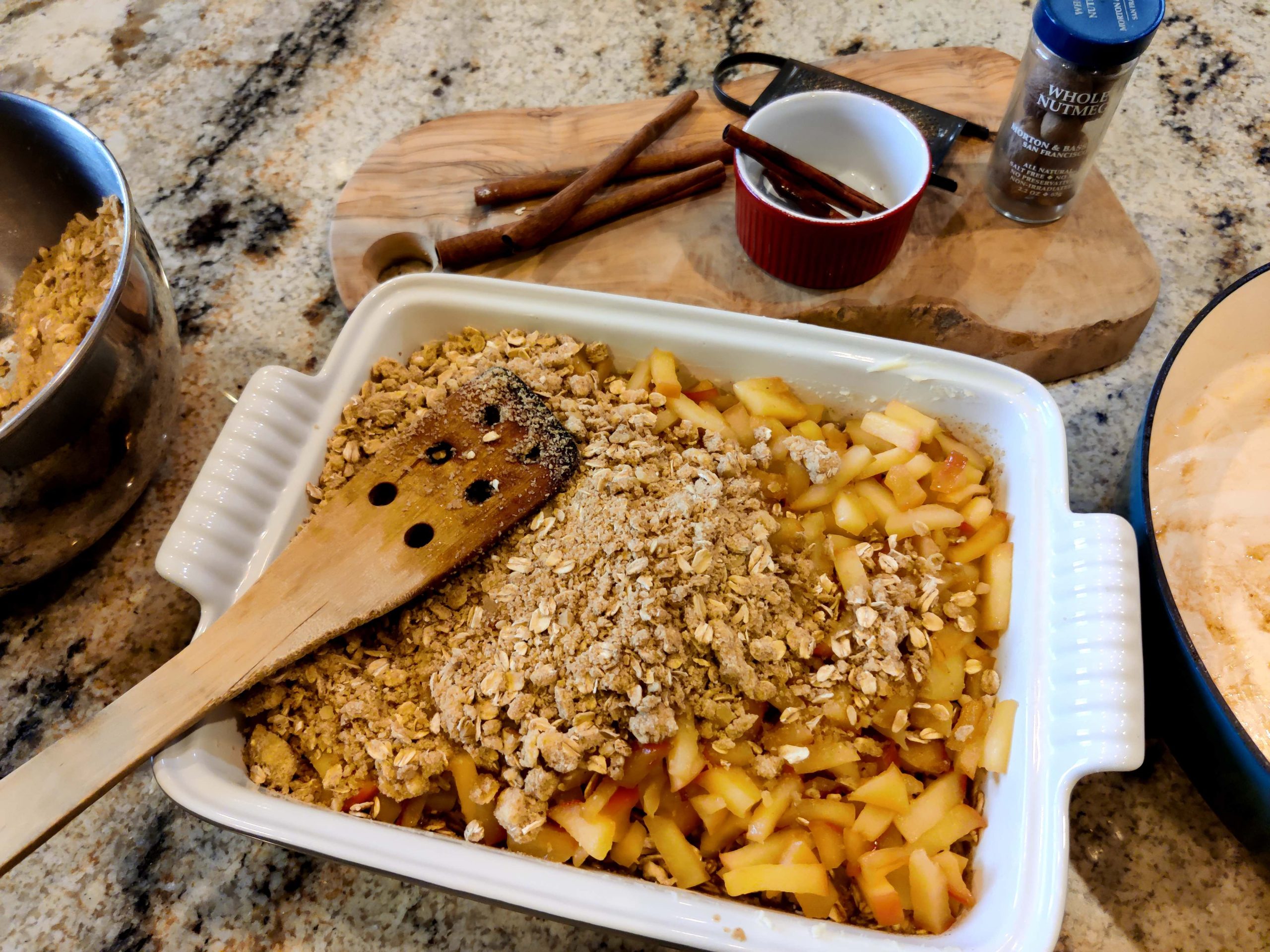 Layering the apple crisp baked oatmeal in a pan