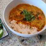 Thai pumpkin curry over rice with cilantro and lime