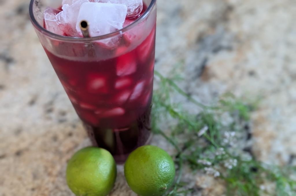 Black currant lime summer drink in a glass.