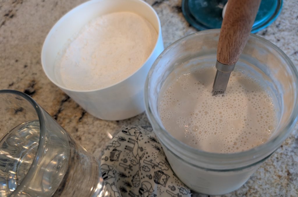 Sourdough starter, flour and water on the counter