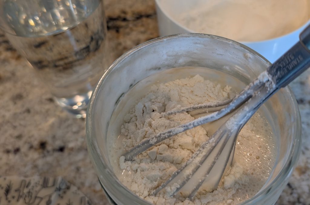 Sourdough starter, mixing in flour to feed it