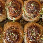 Pistachio cardamom morning buns baked until golden in a baking dish.